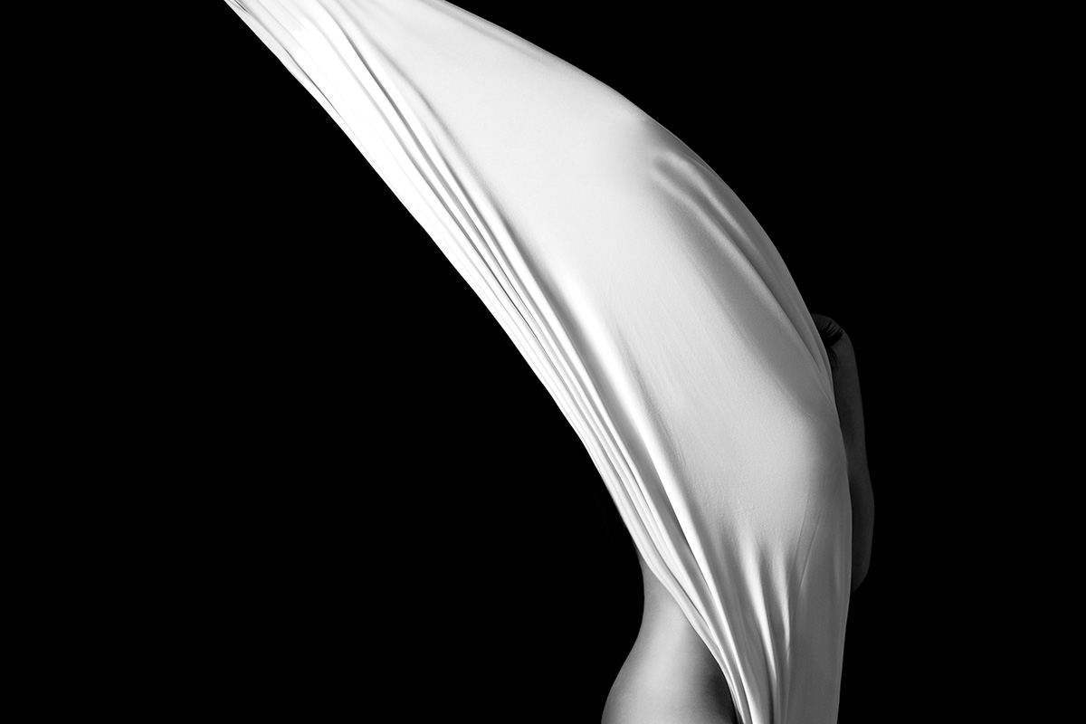 Black Stage: white silk caught mid-fall against black